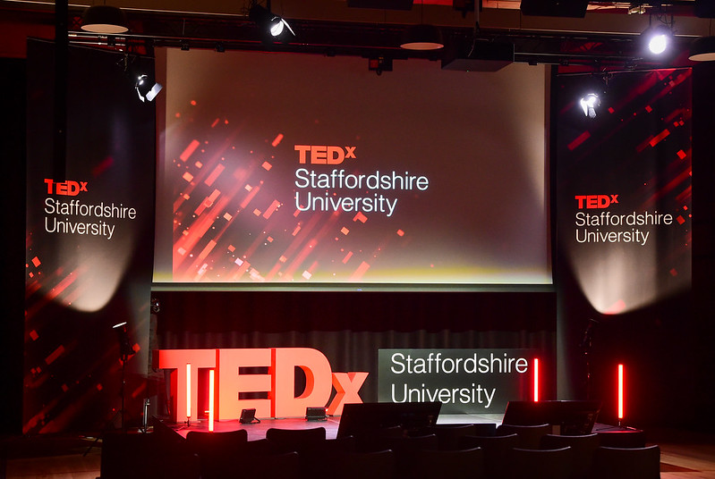 Ted x Staffordshire University stage featuring two banners, one large digital screen and 3D signage.