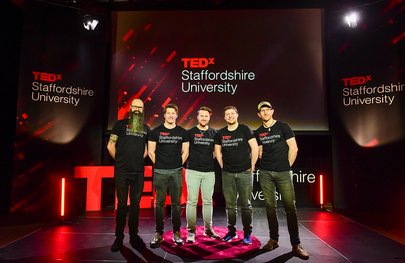 Staffordshire University Technical Services team on the stage, they are all wearing black Ted X Staffordshire univesity t-shirts.
